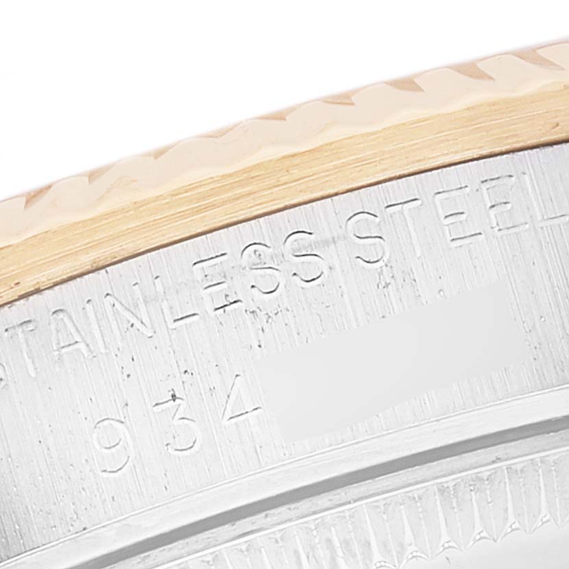 This image shows a close-up of the bezel and part of the casing, featuring the "Stainless Steel" engraving on a Rolex Mid-Size 68273 Women
s Steel and Gold (two tone) White Dial 68273 Women
s Steel and Gold (two tone) White Dial model.