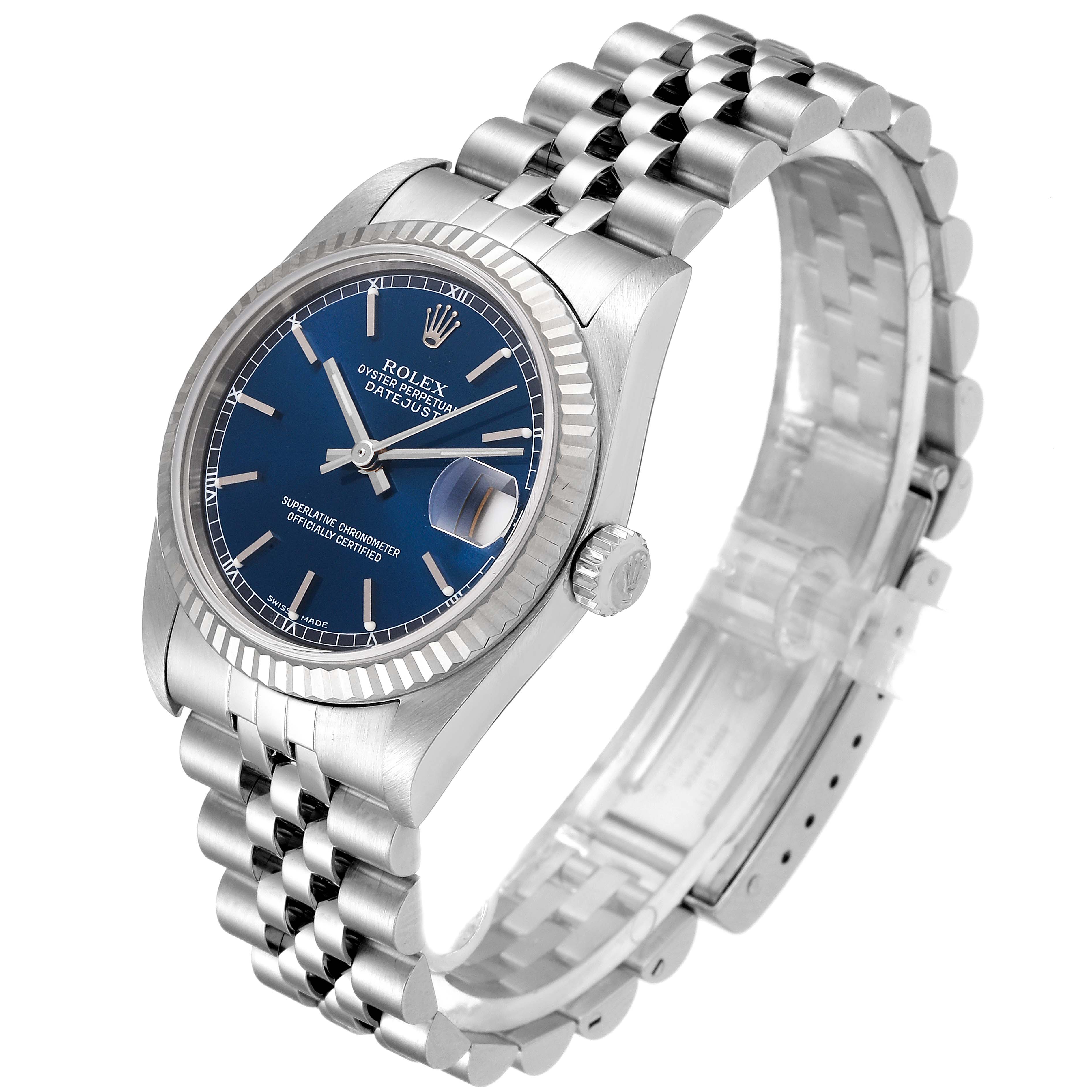 The Rolex Mid-Size 78274 Women's Stainless Steel Blue Dial 78274 Women's Stainless Steel Blue Dial model is shown at a three-quarter angle, displaying its blue dial, fluted bezel, jubilee bracelet, and date window.