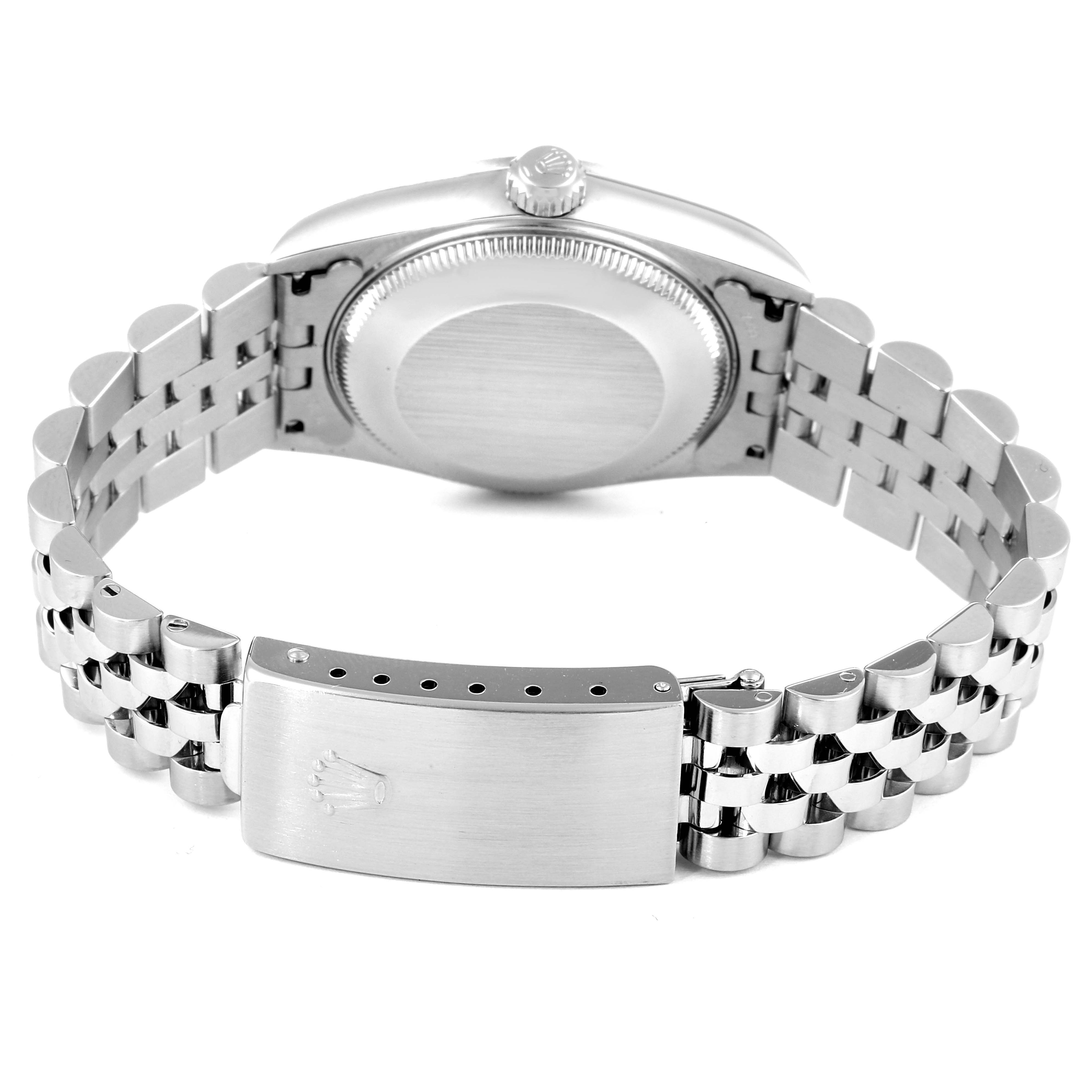 This image shows the back case, crown, and bracelet clasp of a mid-size Rolex watch.