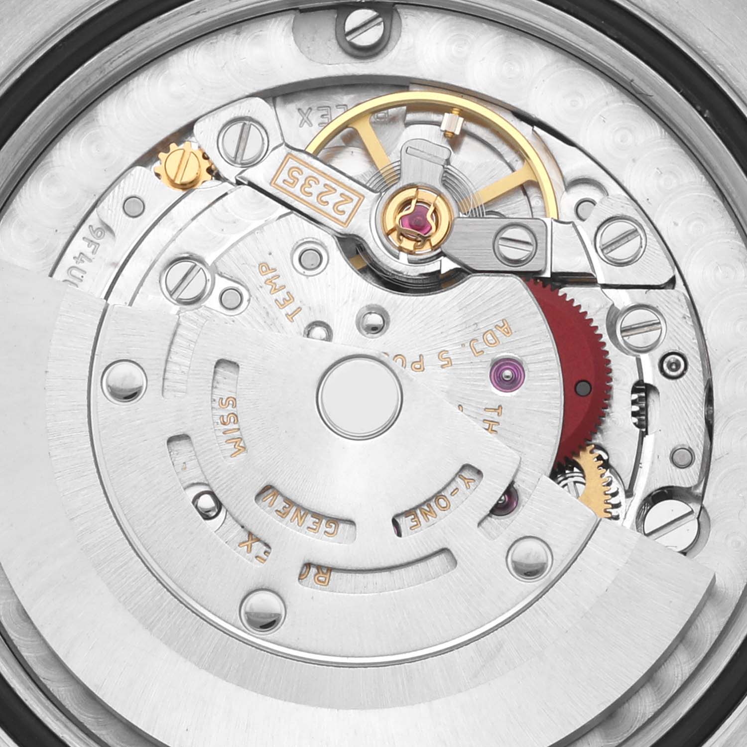 The image shows the movement of a Mid-Size Rolex watch from a top-down angle, highlighting gears and mechanical components.