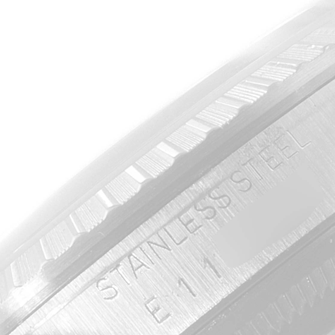 This image shows a close-up of the stainless steel fluted bezel and part of the case back of a Rolex Datejust 16220 Men's Stainless Steel Silver Dial 16220 Men's Stainless Steel Silver Dial watch.