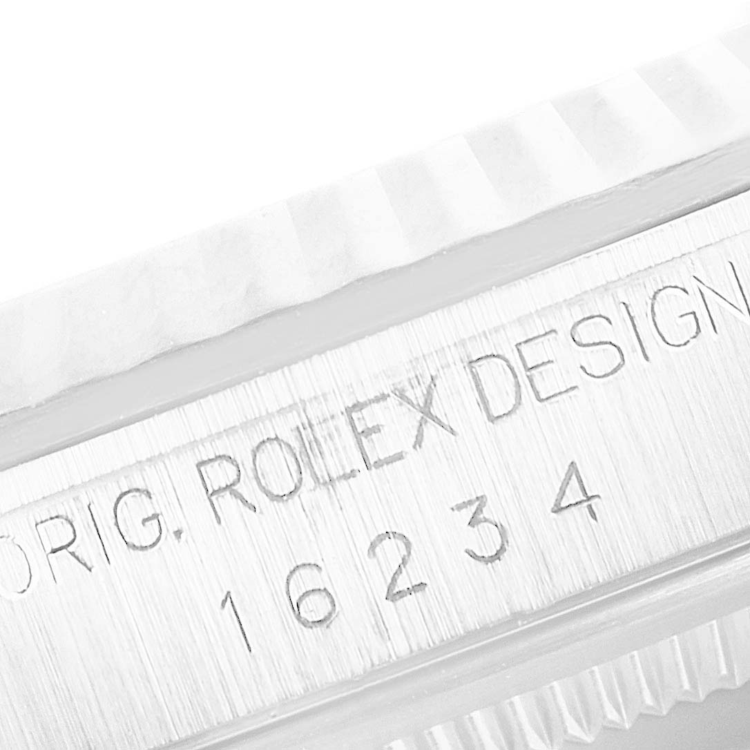 This image shows a close-up of a Rolex Datejust 16234 Men's Stainless Steel Pink Dial 16234 Men's Stainless Steel Pink Dial model, focusing on the serial and design engraving on the case.