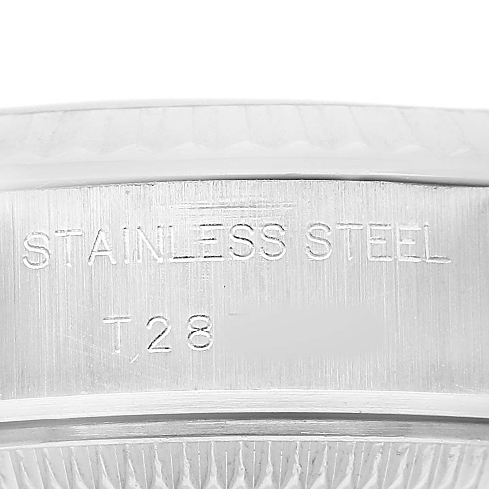 The image shows a close-up of the side of a Rolex Datejust 69174 Women's Stainless Steel Silver Dial, focusing on the stainless steel casing with engraved markings.