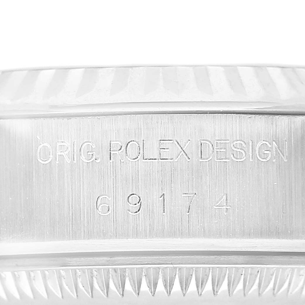 The image shows a close-up of the side of a Rolex Datejust 69174 Women's Stainless Steel Silver Dial, focusing on the engraved model number and "Orig. Rolex Design."