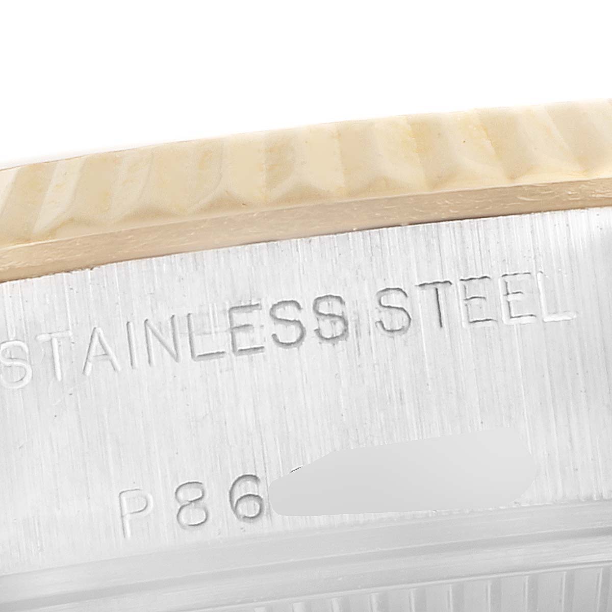 This image shows a close-up of a stainless steel bezel and case with engravings on a Rolex Datejust 79173 Women's Steel and Gold (two tone) Silver Dial 79173 Women's Steel and Gold (two tone) Silver Dial model watch.