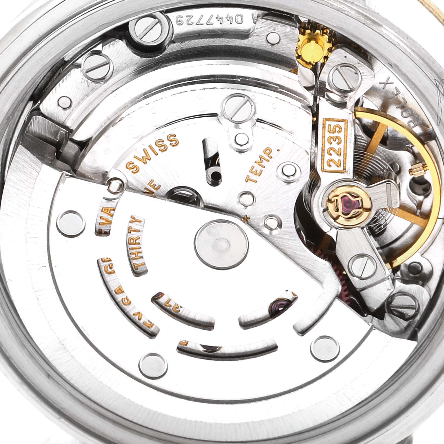 This is a close-up of the internal mechanical movement of a Rolex Datejust 79173 Women's Steel and Gold (two tone) Silver Dial 79173 Women's Steel and Gold (two tone) Silver Dial, showing gears and engraved model details.