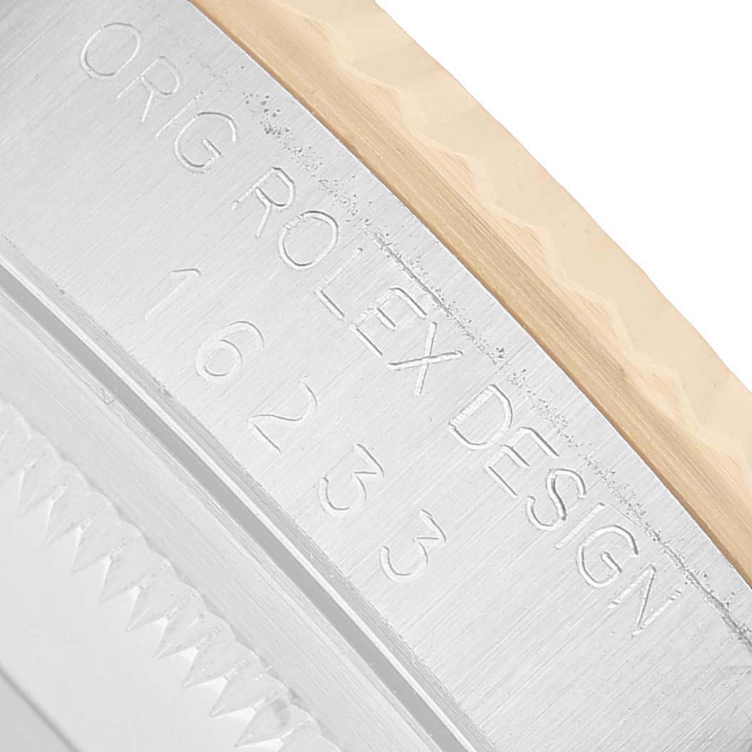 This close-up shows the side view of the case with "ORIG ROLEX DESIGN" engraving on the Rolex Datejust 16233 Men's Stainless Steel Champagne Dial model.