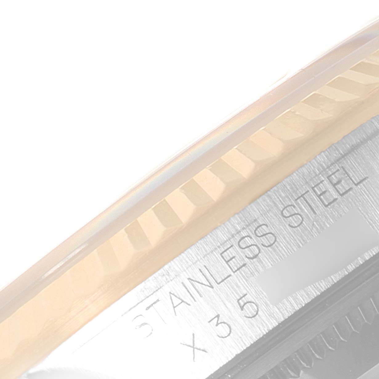 This close-up image shows the stainless steel bezel of a Rolex Datejust 16233 Men's Steel and Gold (two tone) Champagne Dial 16233 Men's Steel and Gold (two tone) Champagne Dial watch with partial serial number details.