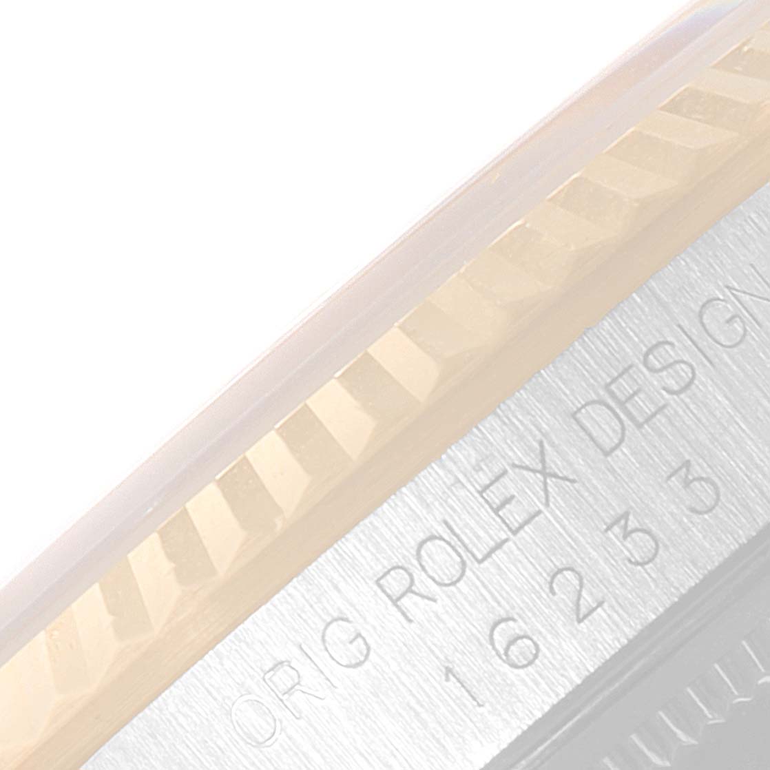 The image shows a close-up of the fluted bezel and part of the engraving near the edge of a Rolex Datejust 16233 Men's Steel and Gold (two tone) Champagne Dial 16233 Men's Steel and Gold (two tone) Champagne Dial watch.