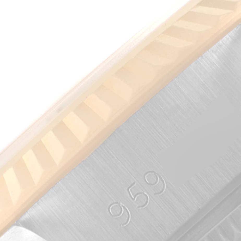 This close-up image of the Rolex Datejust 69173 Women
s Steel and Gold (two tone) Silver Dial 69173 Women
s Steel and Gold (two tone) Silver Dial shows part of its fluted bezel and a portion of the brushed metal case with a reference number.