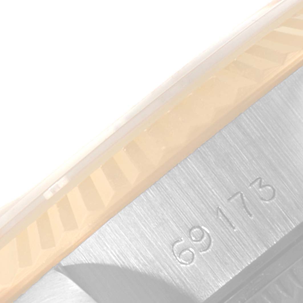 The image shows a close-up of the serial and model number engraving on the case of a Rolex Datejust 69173 Women
s Steel and Gold (two tone) Silver Dial 69173 Women
s Steel and Gold (two tone) Silver Dial watch.