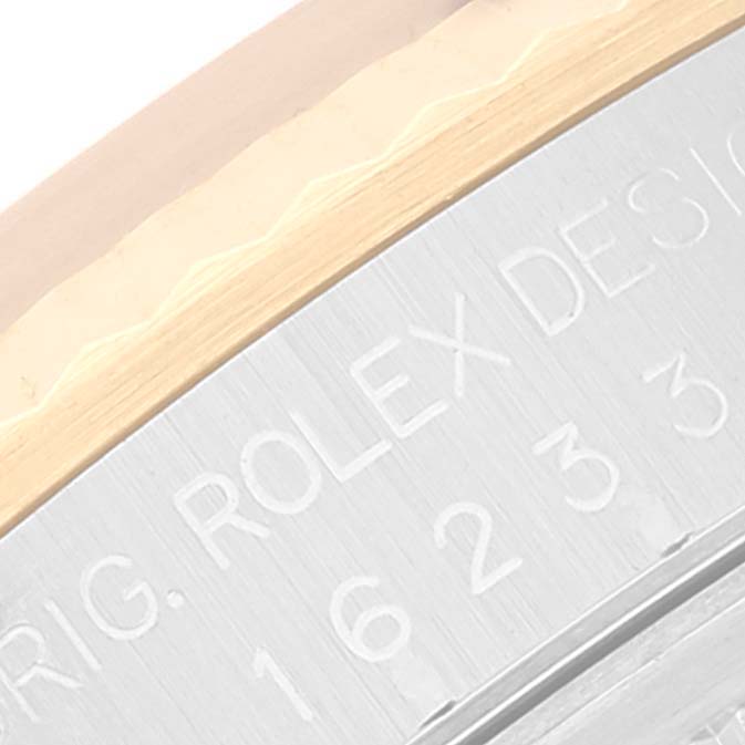 The image shows a close-up view of the side of a Rolex Datejust 16233 Men's Steel and Gold (two tone) Mother of Pearl Dial 16233 Men's Steel and Gold (two tone) Mother of Pearl Dial watch, highlighting the fluted bezel and engraved model details.