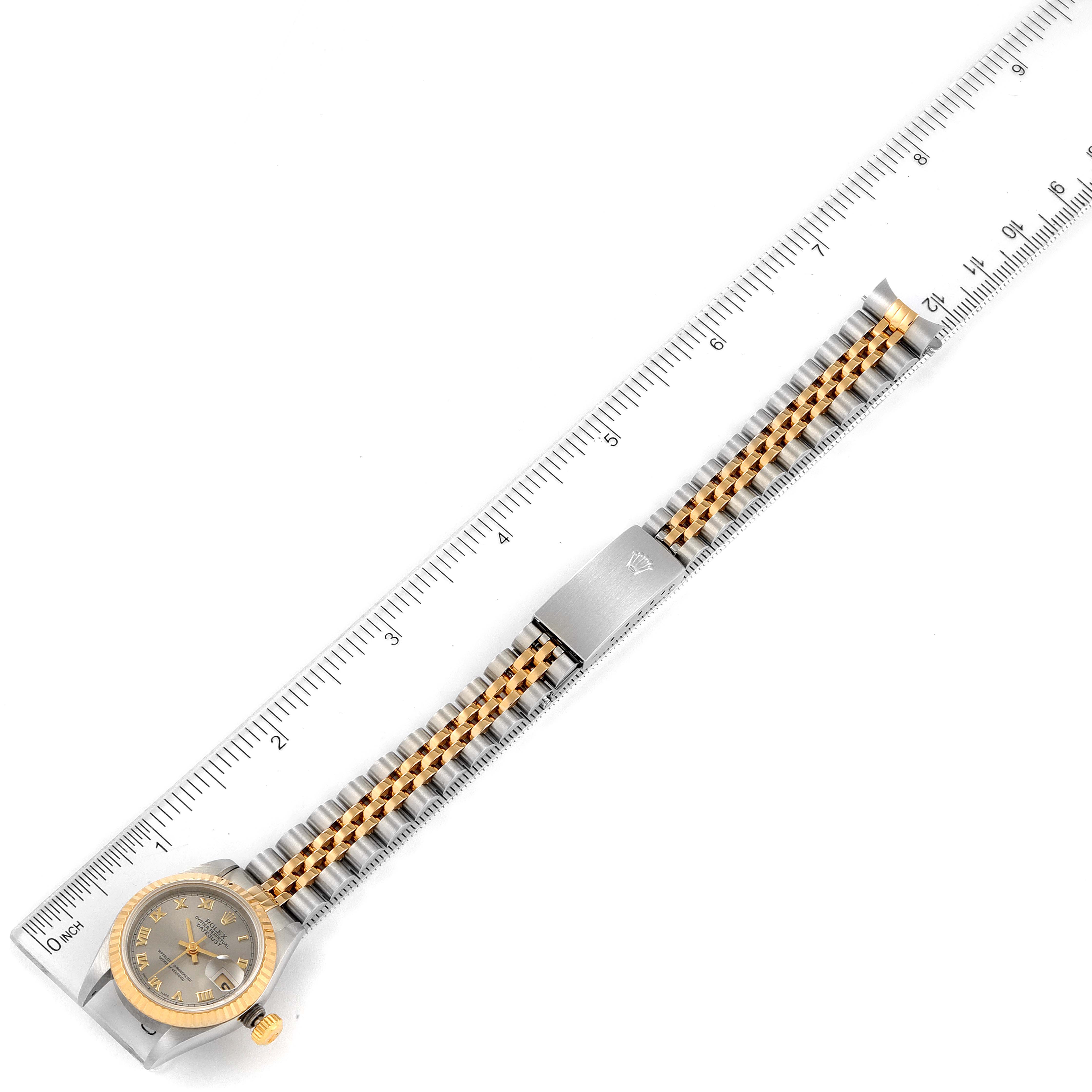 The image shows a top-down view of a Rolex Datejust 69173 Women
s Steel and Gold (two tone) Grey Dial 69173 Women
s Steel and Gold (two tone) Grey Dial watch, showcasing its face, bracelet, and clasp, measured with a ruler.