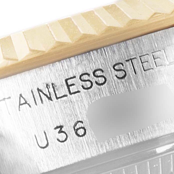 This image shows a close-up of the bezel and stainless steel case of a Rolex Datejust 69173 Women
s Steel and Gold (two tone) Grey Dial 69173 Women
s Steel and Gold (two tone) Grey Dial watch at an angled view.