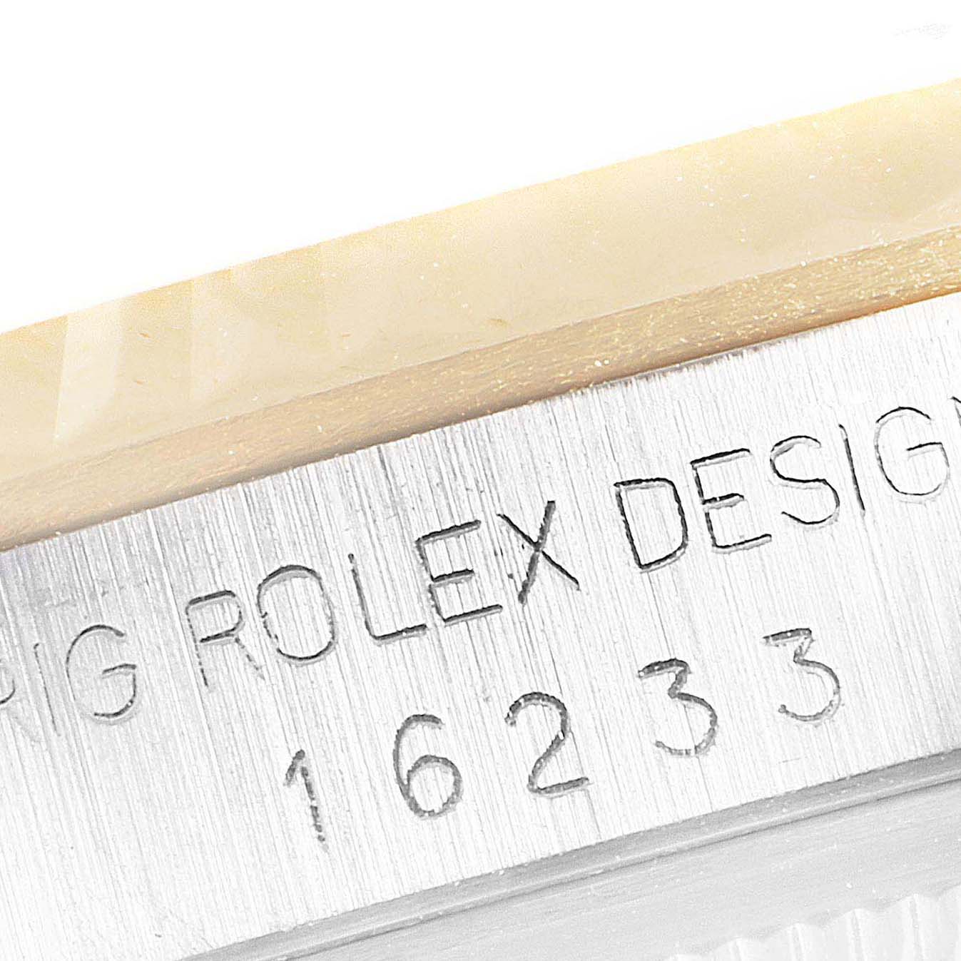 This close-up image shows the side of the Rolex Datejust 16233 Men's Steel and Gold (two tone) Blue Dial 16233 Men's Steel and Gold (two tone) Blue Dial watch case, featuring the brand and model number engraving.