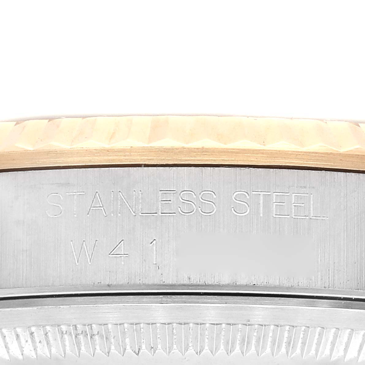 This image shows a close-up of the stainless steel back case and fluted bezel of a Rolex Datejust 16233 Men's Steel and Gold (two tone) Purple Dial 16233 Men's Steel and Gold (two tone) Purple Dial watch.