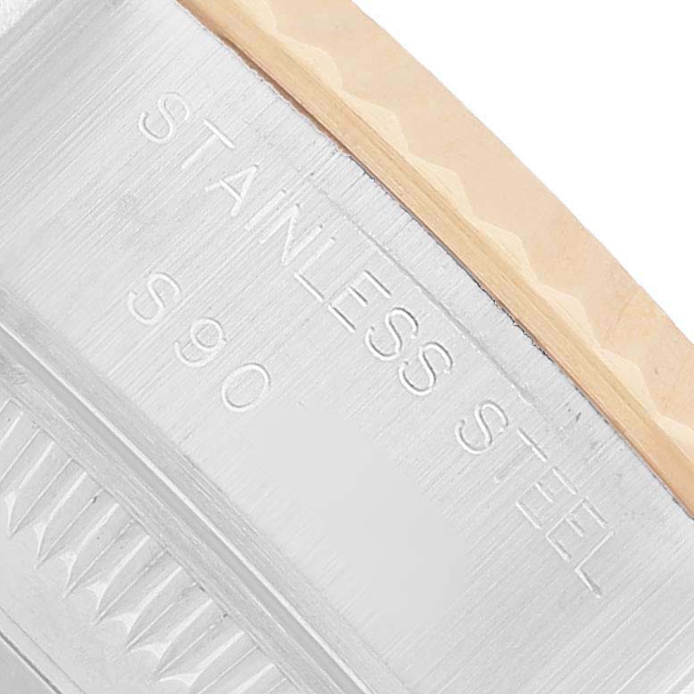 The image shows a close-up of the edge of a Rolex Datejust 69173 Women's Steel and Gold (two tone) White Dial case with "STAINLESS STEEL" and "S90" engraved on it.