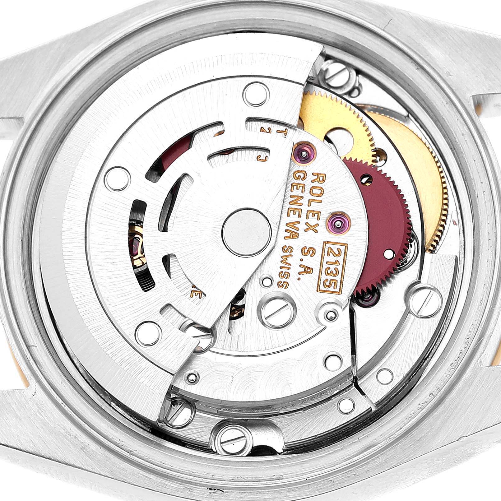The image shows the inner mechanical movement of a Rolex Datejust 69163 Women's Steel and Gold (two tone) White Dial from a top-down angle, highlighting gears and rotors.