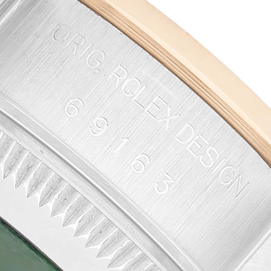 The image shows a close-up of the side engraving on a Rolex Datejust 69163 Women's Steel and Gold (two tone) White Dial bezel, highlighting the "ORIG ROLEX DESIGN" marking and numbers.