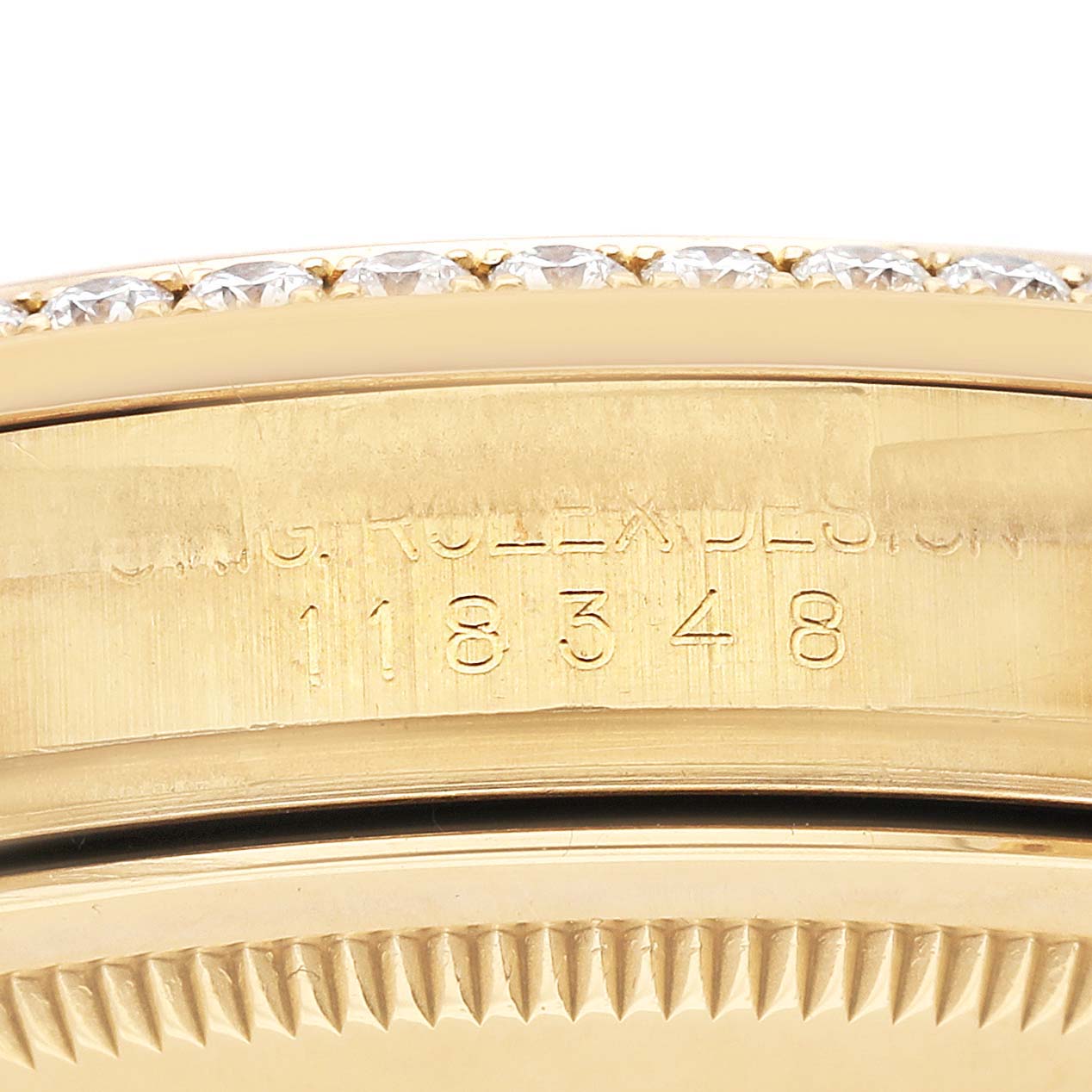 The image shows a close-up of the bezel and case edge with engravings on the Rolex President 118348 Men's Yellow Gold Champagne Dial 118348 Men's Yellow Gold Champagne Dial model.
