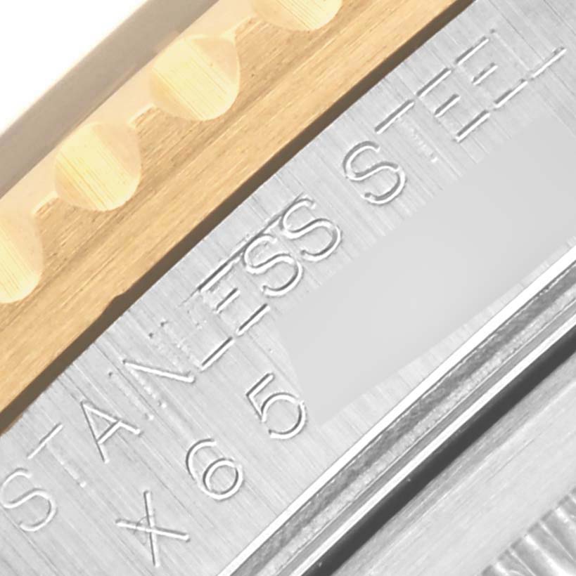 The image shows a close-up of the Rolex GMT-Master 16713 Men's Steel and Gold (two tone) Black Dial 16713 Men's Steel and Gold (two tone) Black Dial's stainless steel and gold bezel with engraved markings.