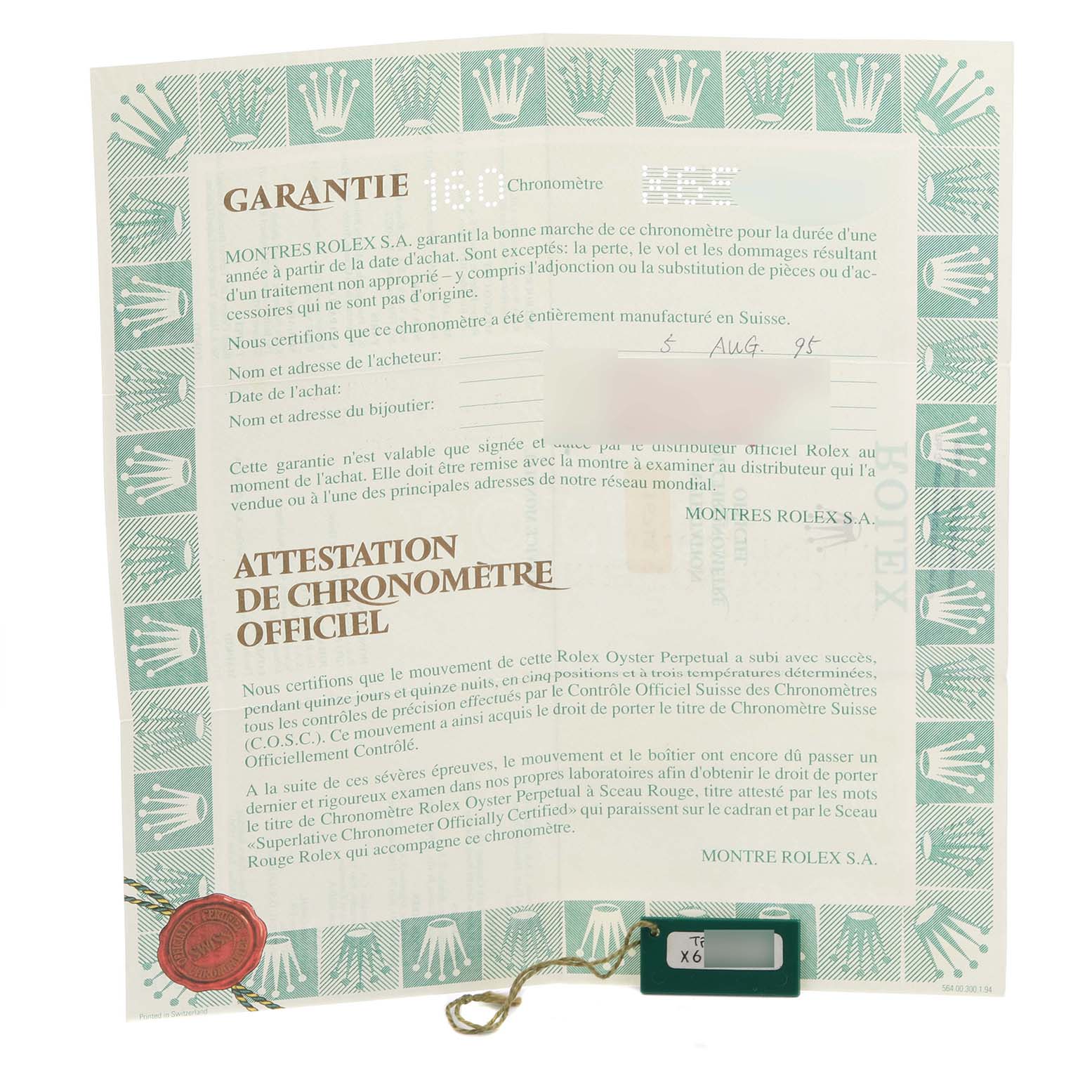 The image shows a warranty document and tag for the Rolex GMT-Master 16713 Men's Steel and Gold (two tone) Black Dial 16713 Men's Steel and Gold (two tone) Black Dial watch model.