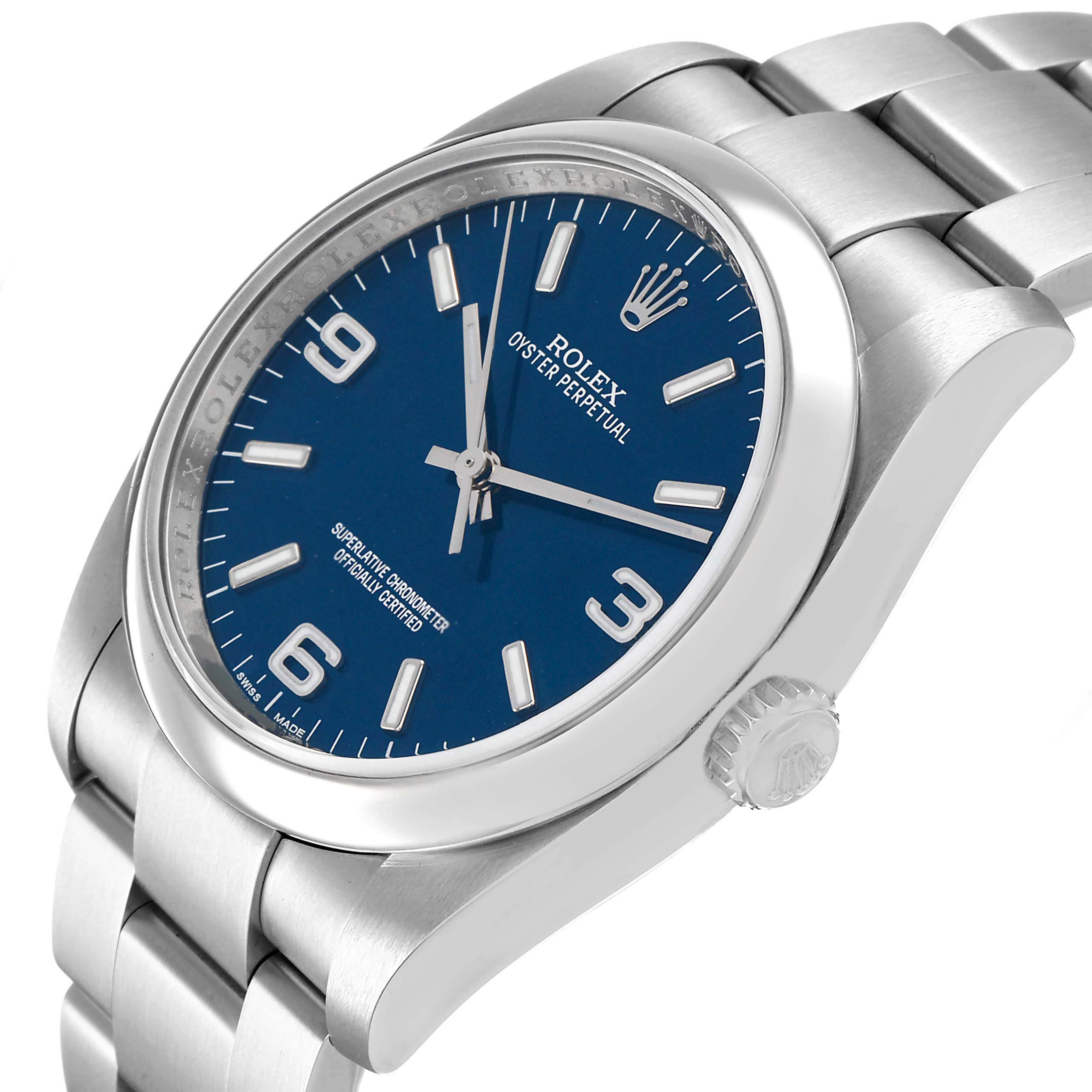 The Rolex Oyster Perpetual 116000 Men's Stainless Steel Blue Dial watch is shown at a slight angle, highlighting the dial, bezel, crown, and part of the bracelet.