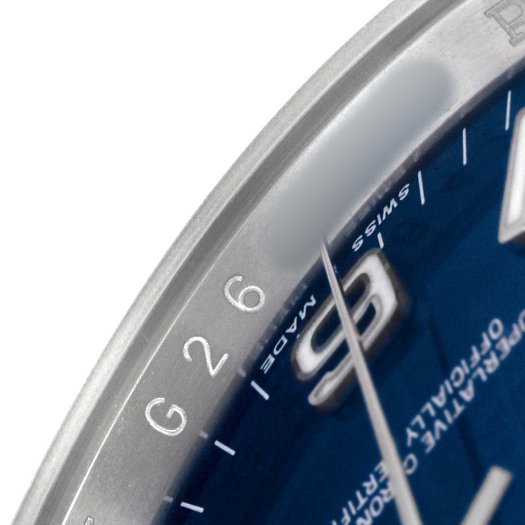 The image shows a close-up of the dial and bezel edge of a Rolex Oyster Perpetual 116000 Men's Stainless Steel Blue Dial watch, highlighting the "Swiss Made" text.