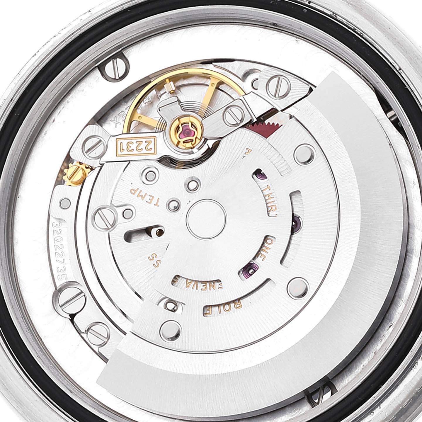 The image shows the inner mechanism of a Mid-Size Rolex watch, viewed from the back, highlighting the rotor and balance wheel.