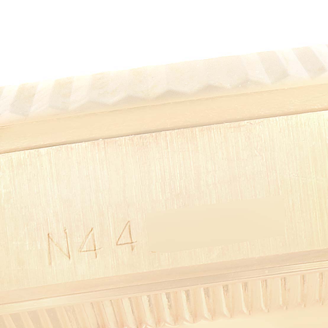 This close-up image shows the side engraving and partial fluted bezel of a Rolex President 68278 Women
s Yellow Gold Champagne Dial 68278 Women
s Yellow Gold Champagne Dial model.