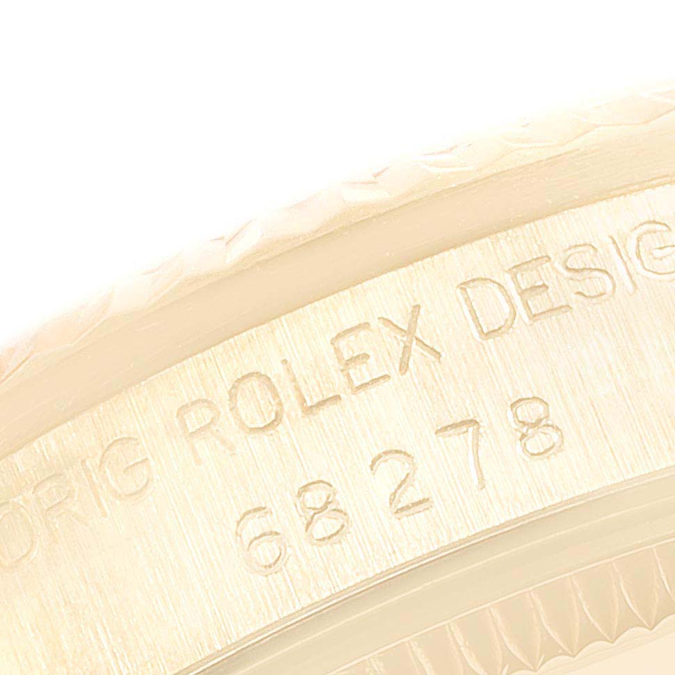 The image shows a close-up of the edge and engraved design number on the case of a Rolex President 68278 Women
s Yellow Gold Champagne Dial 68278 Women
s Yellow Gold Champagne Dial model watch.