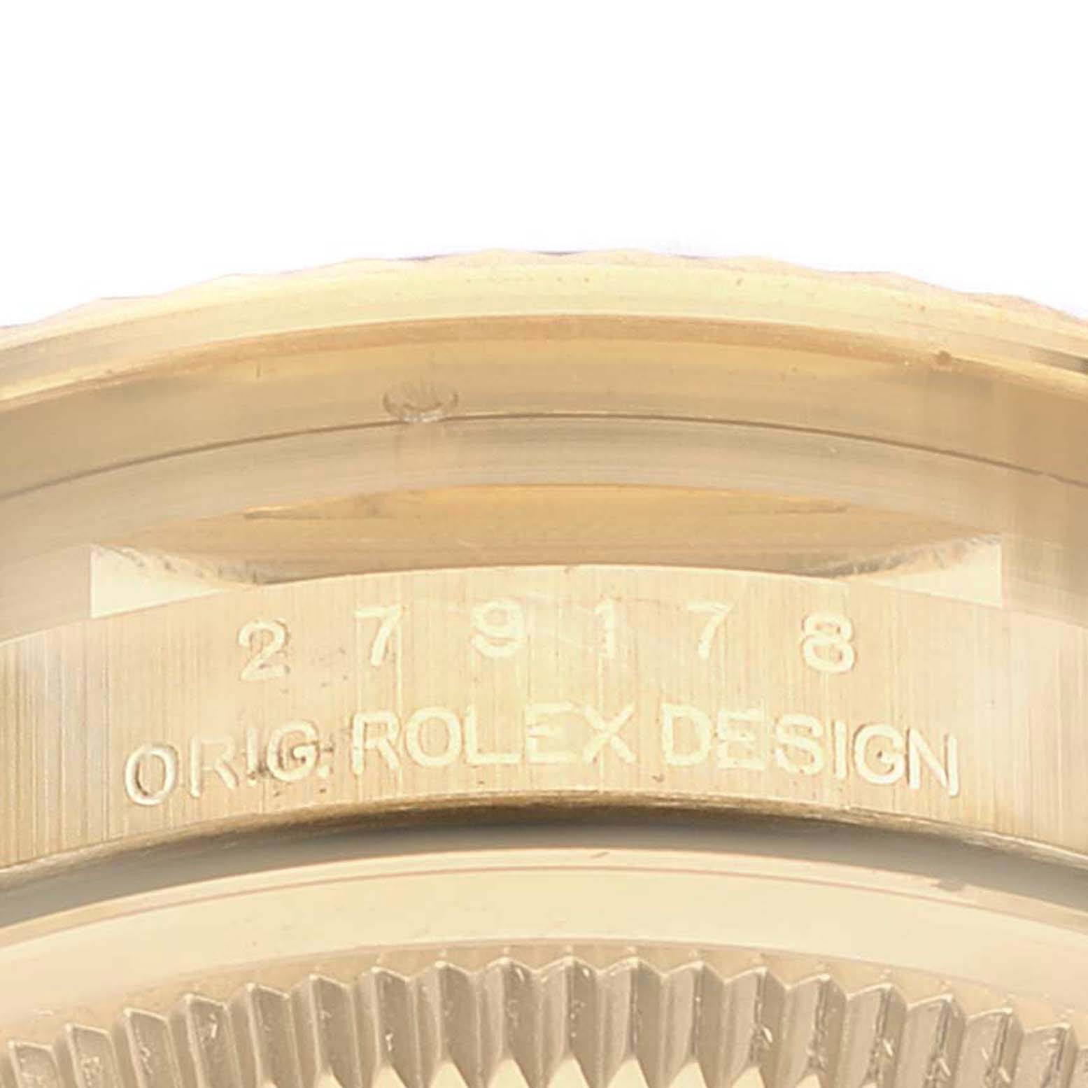 The image shows a close-up view of the Rolex President 279178 Women
s Yellow Gold Champagne Dial 279178 Women
s Yellow Gold Champagne Dial model
s case back, displaying the serial number and the engraving "ORIG. ROLEX DESIGN."