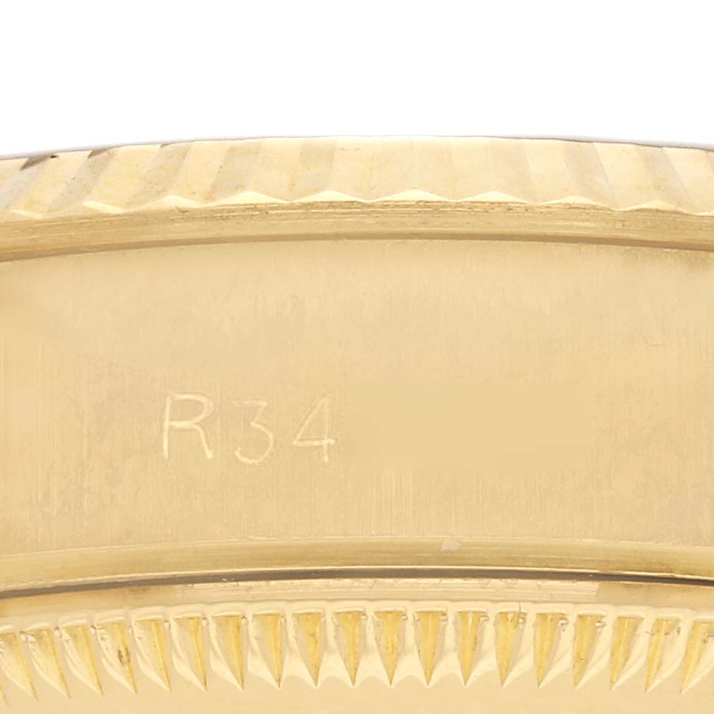 The image shows a close-up angle of the fluted bezel on a Rolex President 69178 Women's Yellow Gold White Dial 69178 Women's Yellow Gold White Dial model watch.