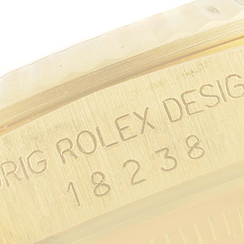 The image shows a close-up of the engraved side of a Rolex President 18238 Men's Yellow Gold Champagne Dial 18238 Men's Yellow Gold Champagne Dial model watch, focusing on the model number and design engraving.