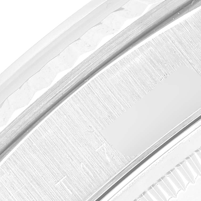 This close-up image shows the engraved bezel and edge of the dial of a Rolex President 18239 Men's White Gold Silver Dial 18239 Men's White Gold Silver Dial model watch.