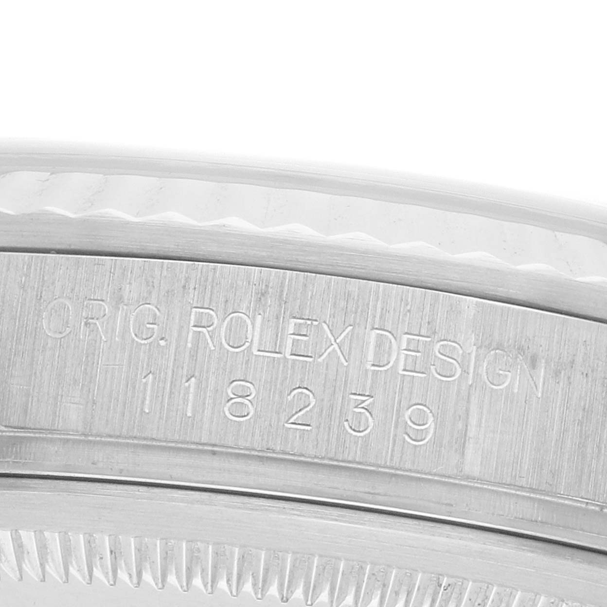 The image shows an angled close-up of the case side of a Rolex President 118239 Men's White Gold Silver Dial, displaying the engraved serial number and "ORIG. ROLEX DESIGN."
