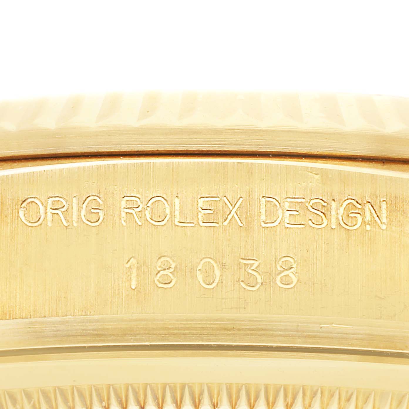 The image shows the side engraving of a Rolex President 18038 Men's Yellow Gold Champagne Dial 18038 Men's Yellow Gold Champagne Dial model watch, displaying "ORIG ROLEX DESIGN" and the number "18038."