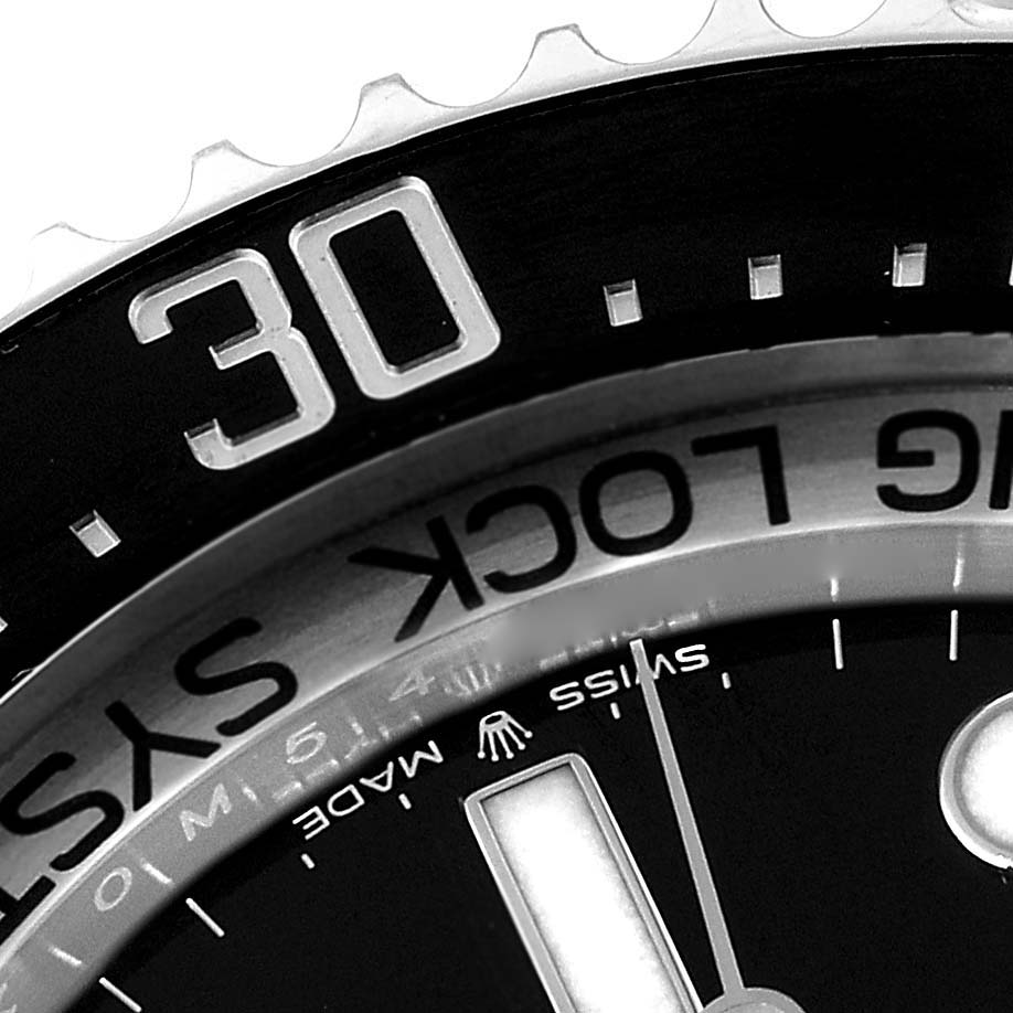 The image shows a close-up of the bezel and part of the dial of a Rolex Sea-Dweller 126660 Men
s Stainless Steel Black Dial 126660 Men
s Stainless Steel Black Dial watch.