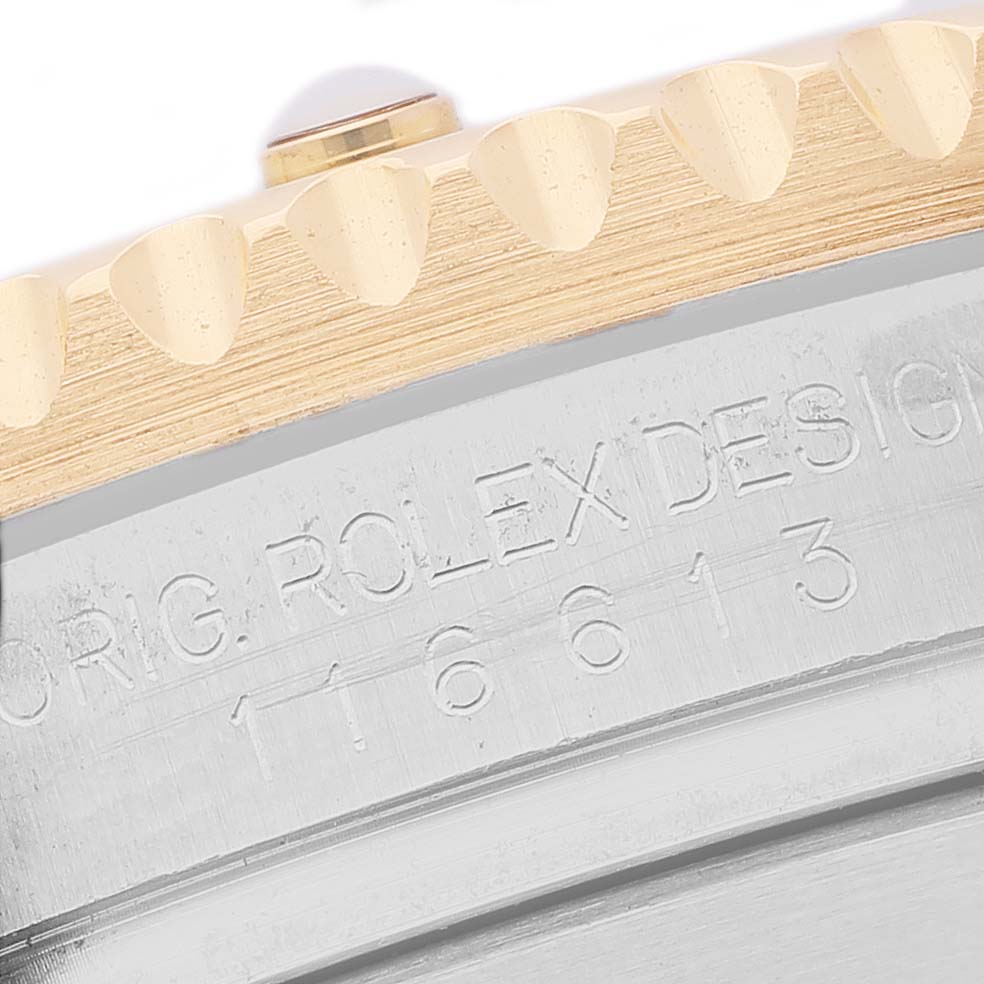 The image shows a close-up of the bezel and case side of a Rolex Submariner 116613 Men's Steel and Gold (two tone) Blue Dial, with "ORIG. ROLEX DESIGN" and model number engraved.