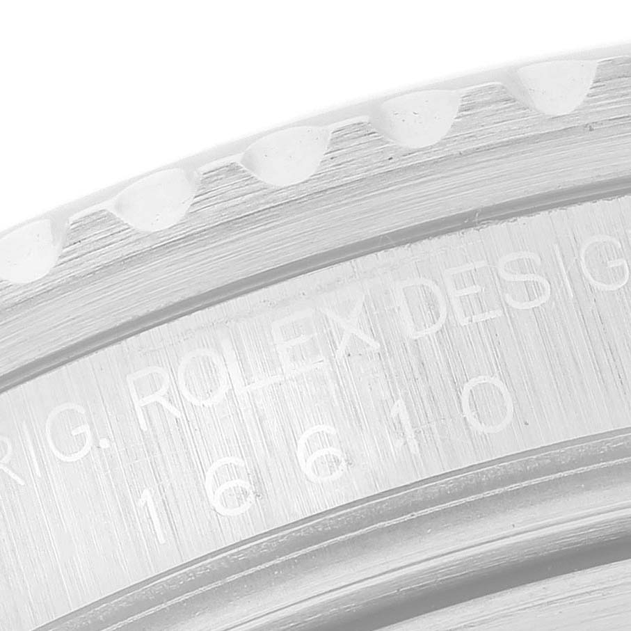 This image shows a close-up view of the engraved edge of a Rolex Submariner 16610 Men's Stainless Steel Black Dial's case, highlighting the model number.