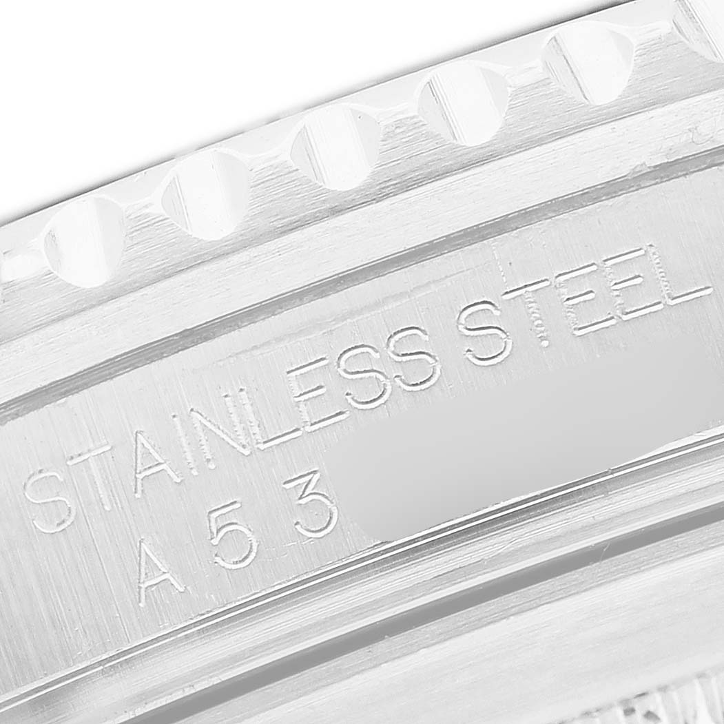 The image shows a close-up of a Rolex Submariner 16610 Men's Stainless Steel Black Dial's stainless steel case with engraved lettering.