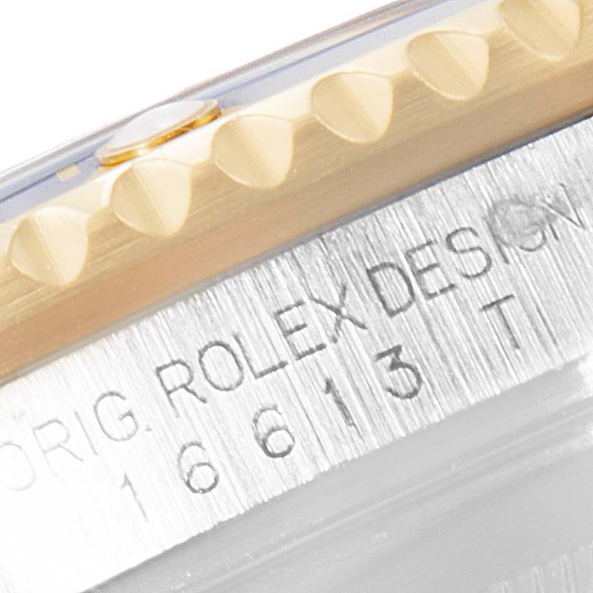 The image shows a close-up of the bezel and engraved serial number on a Rolex Submariner 16613 Men's Steel and Gold (two tone) Champagne Dial 16613 Men's Steel and Gold (two tone) Champagne Dial watch.