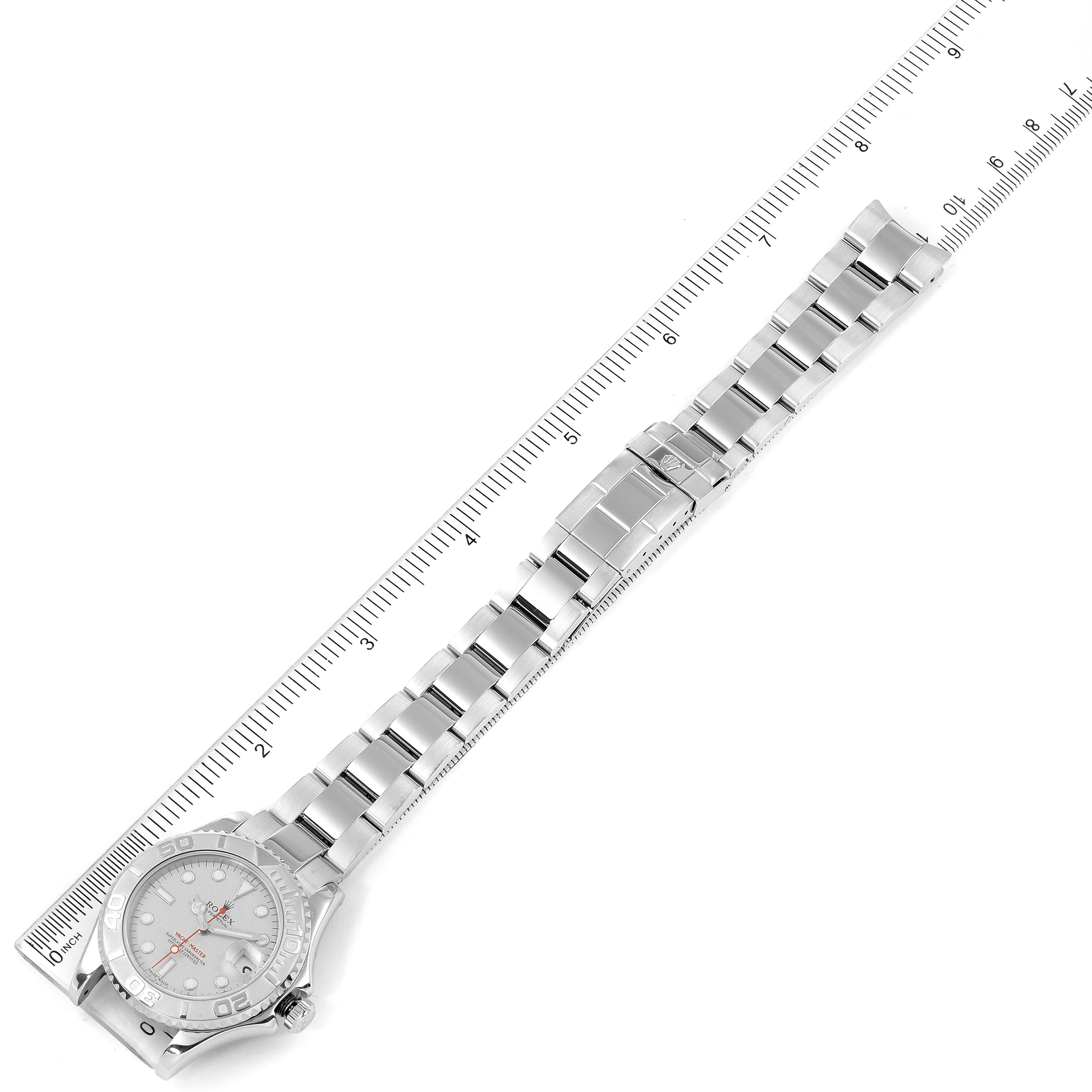 This is an overhead view of a Rolex Yacht-Master 168622 Men
s Stainless Steel Silver Dial 168622 Men
s Stainless Steel Silver Dial watch showing the dial, bracelet, and clasp, aligned with a measuring ruler.