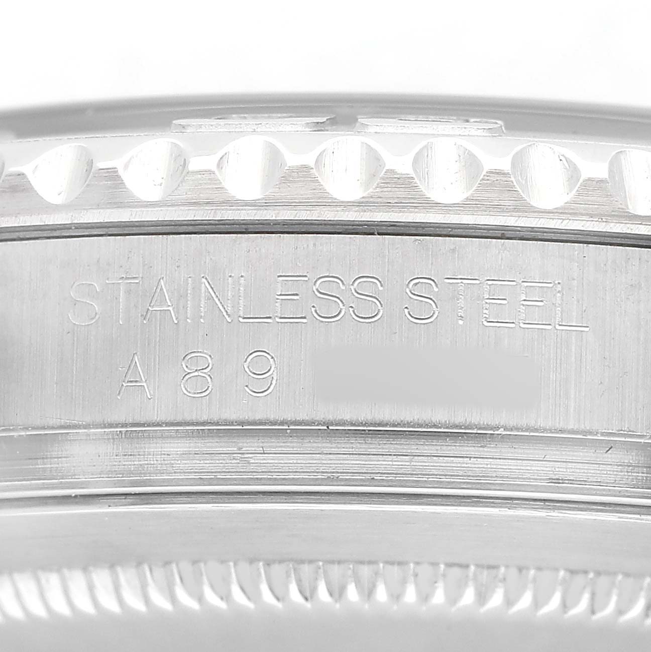 The image shows the side view of a Rolex Yacht-Master 16622 Men's Stainless Steel Silver Dial's stainless steel bezel with engravings visible.