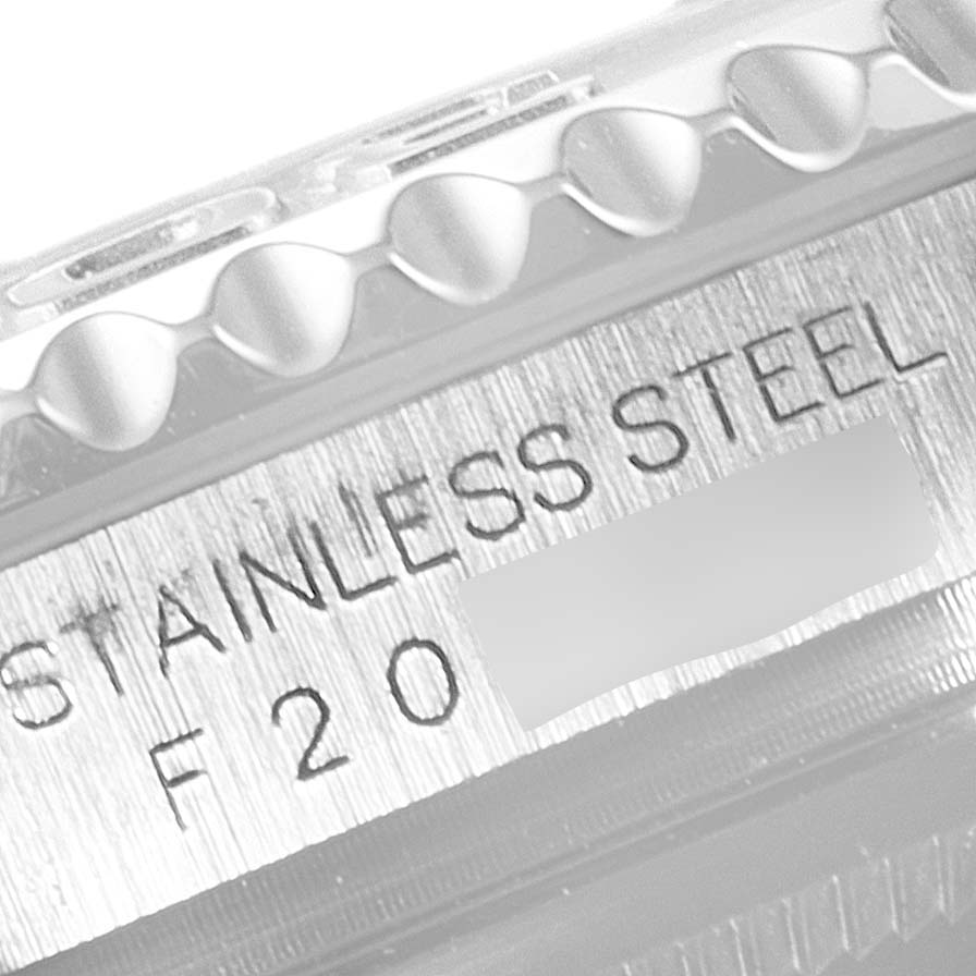 A close-up of the side of a Rolex Yacht-Master 16622 Men
s Stainless Steel Silver Dial 16622 Men
s Stainless Steel Silver Dial watch showing the stainless steel engraving and part of the bezel.