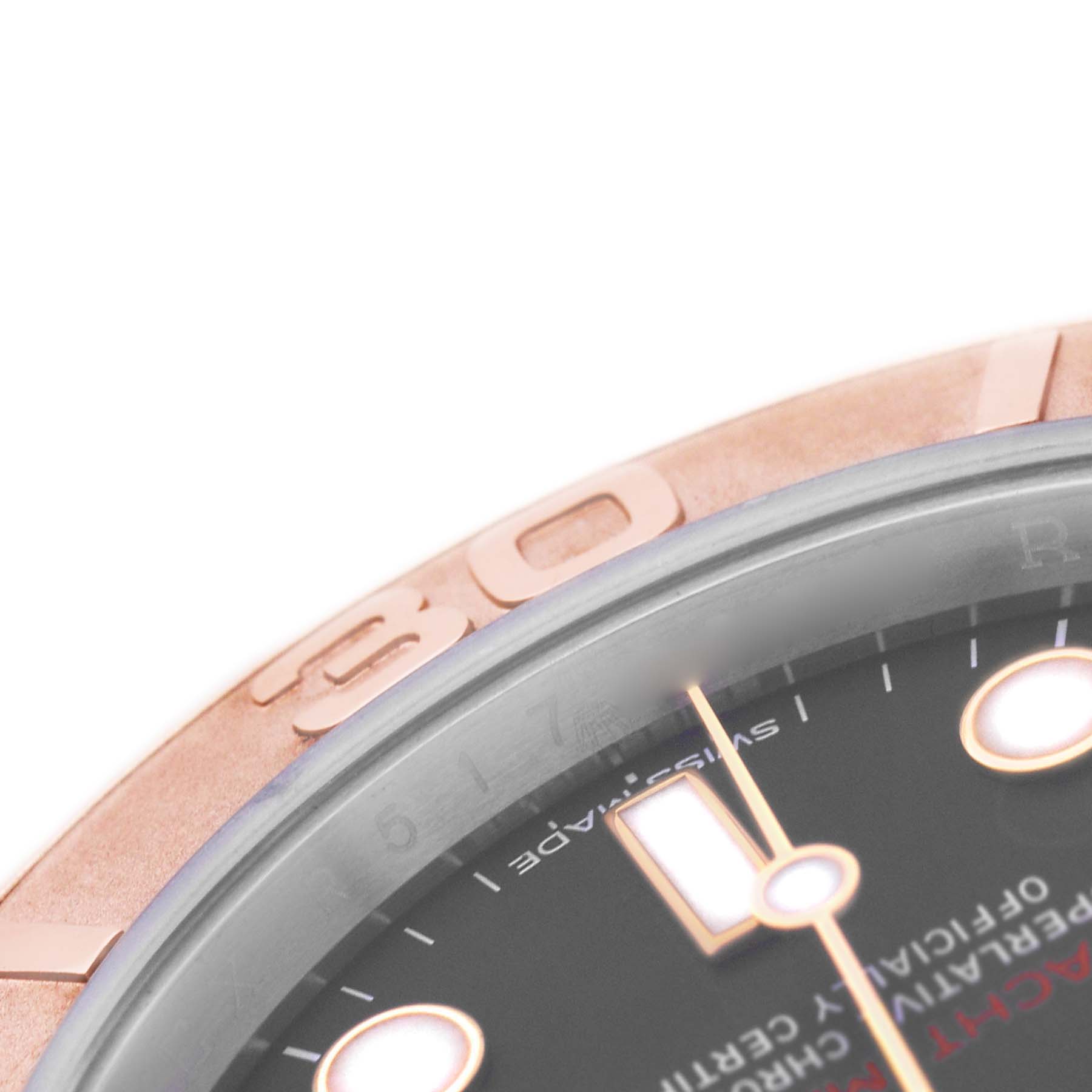The image shows a close-up angle of the Rolex Yacht-Master 116621 Men's Steel and Gold (two tone) Brown Dial's bezel and a portion of the dial with markers.