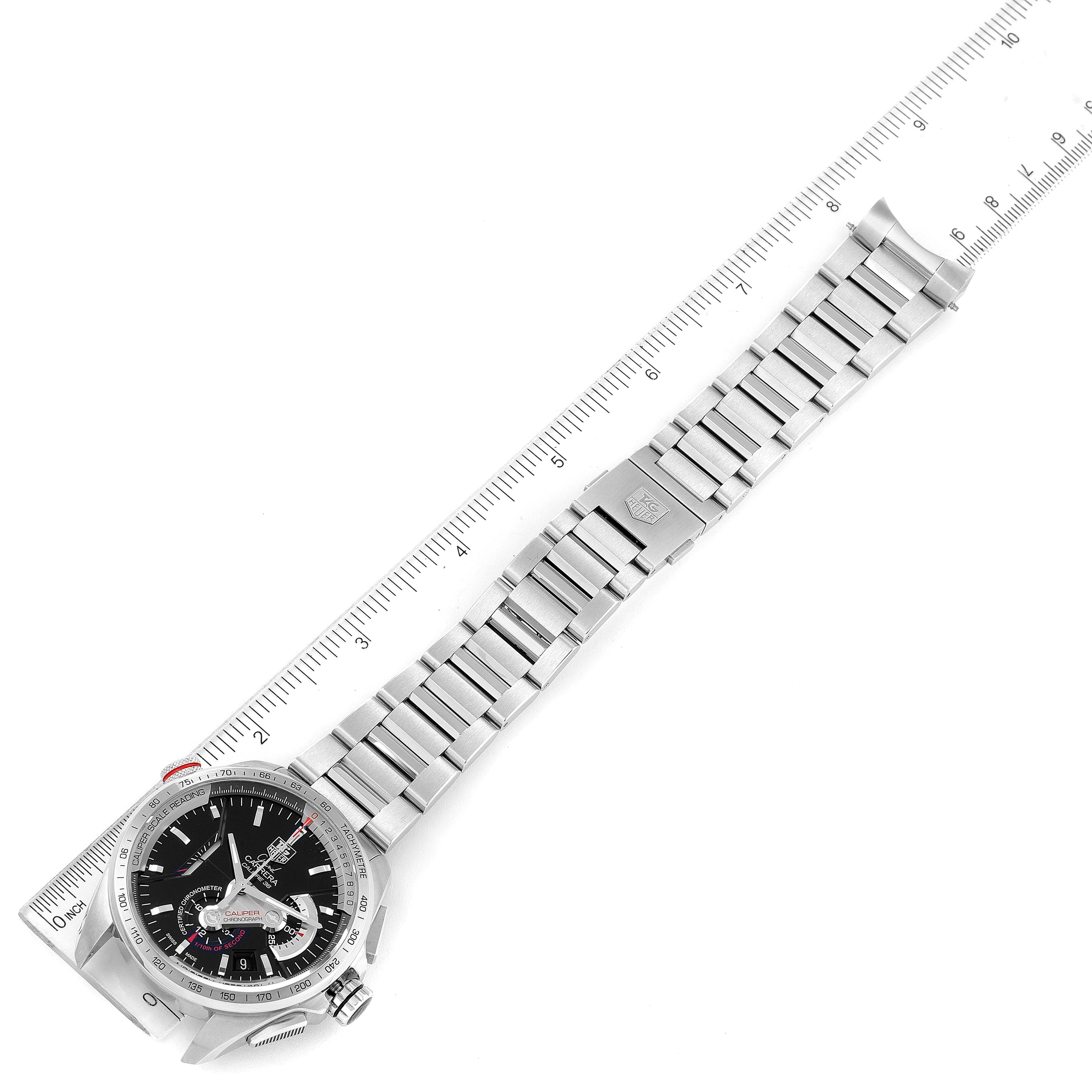 The image shows a Tag Heuer Carrera CAV5115.BA0902 Men's Stainless Steel Black Dial CAV5115.BA0902 Men's Stainless Steel Black Dial watch laid flat next to a ruler, displaying the face and metal bracelet band.