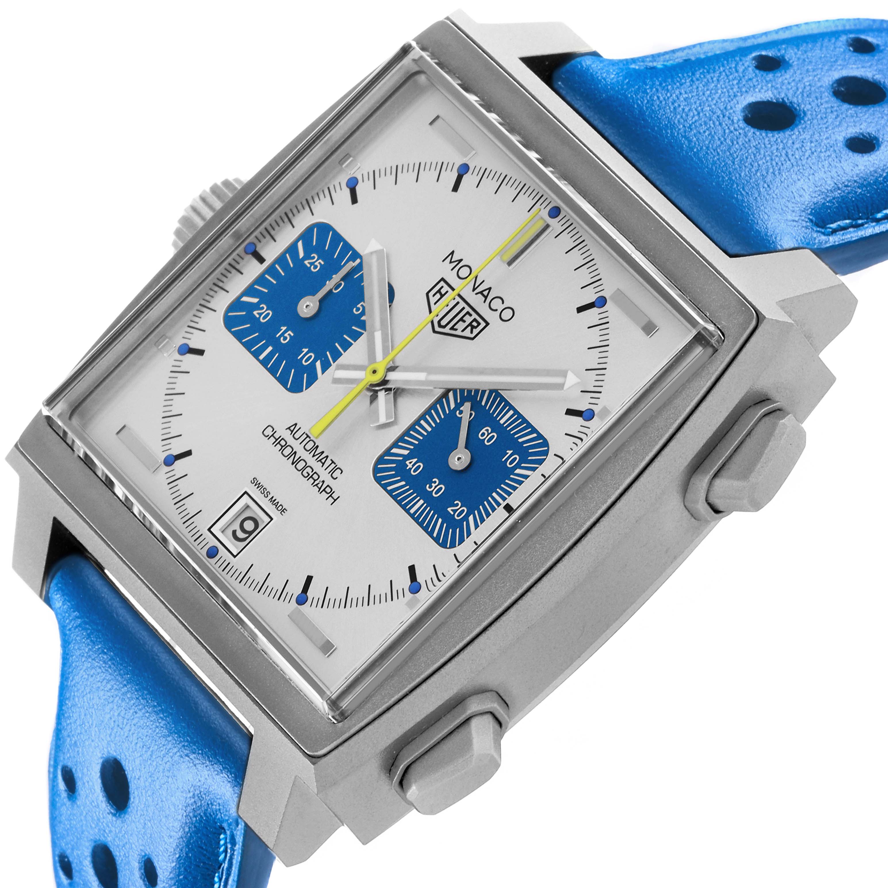 The Tag Heuer Monaco CAW218C.FC6548 Men's Titanium Silver Dial CAW218C.FC6548 Men's Titanium Silver Dial watch is shown at an angle highlighting the face, side buttons, and blue strap.