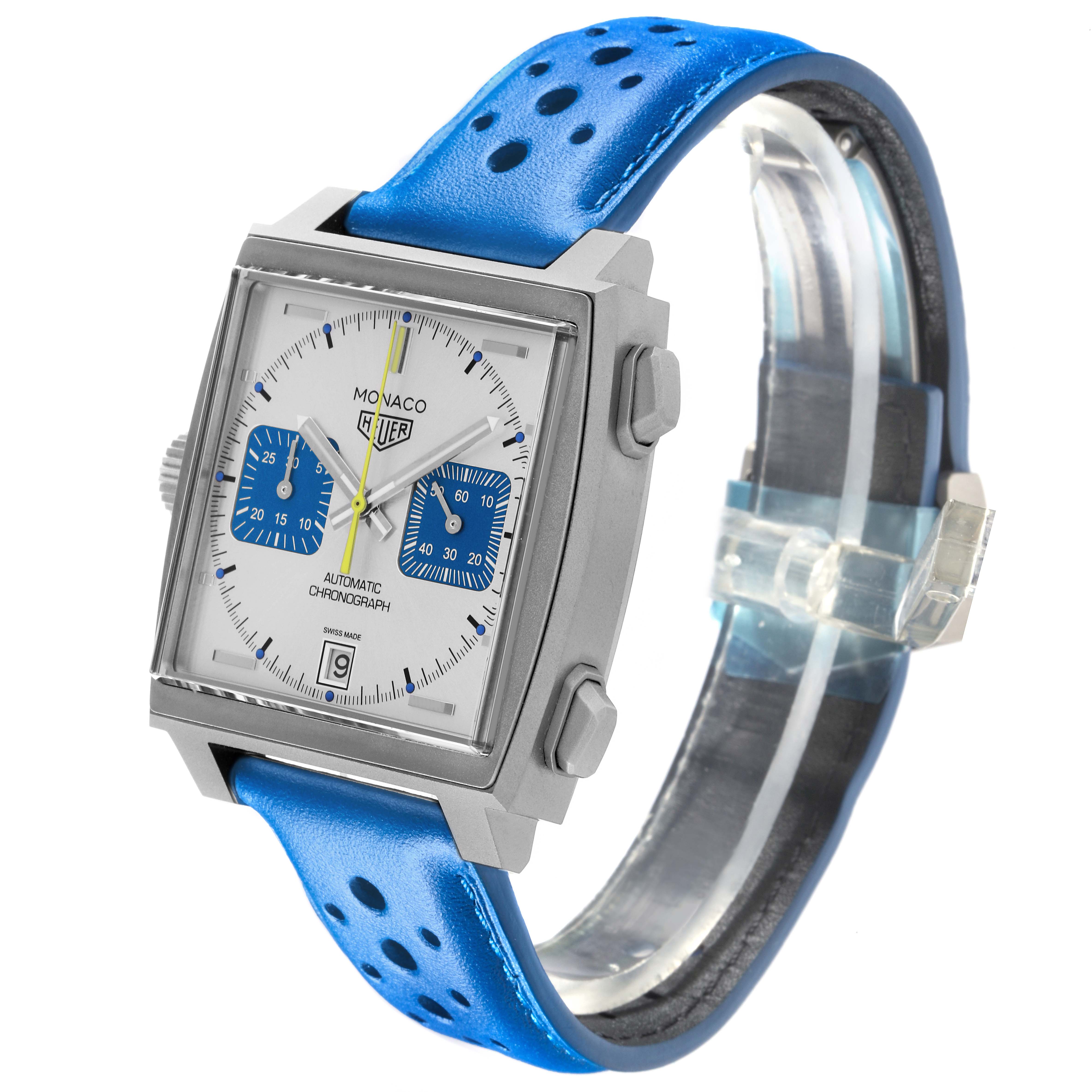 The Tag Heuer Monaco CAW218C.FC6548 Men's Titanium Silver Dial CAW218C.FC6548 Men's Titanium Silver Dial watch is shown at a slight angle, highlighting its square face, chronograph dials, and blue perforated strap.