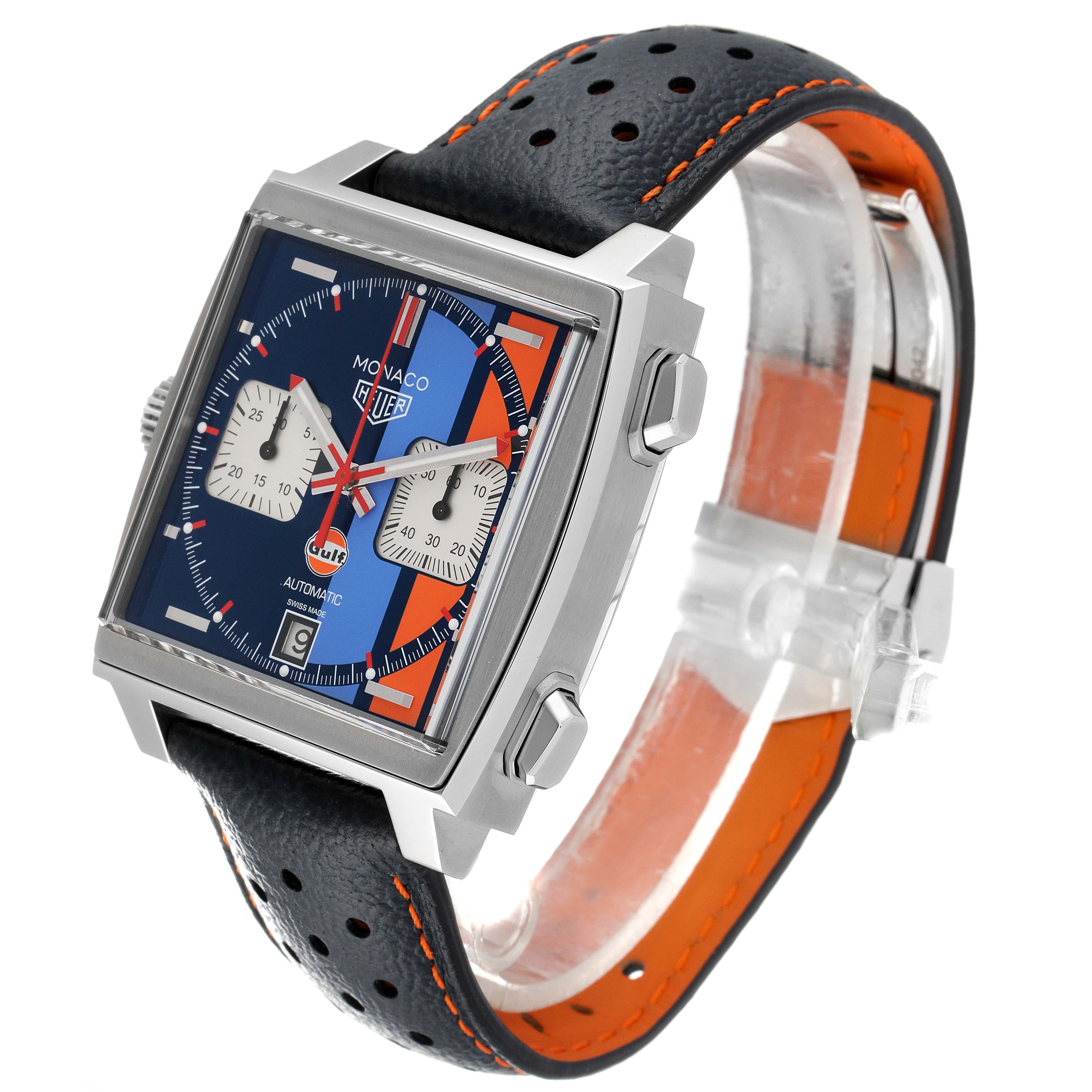 The image shows an angled view of the Tag Heuer Monaco CAW211R.FC6401 Men's Stainless Steel Blue Dial CAW211R.FC6401 Men's Stainless Steel Blue Dial watch, highlighting its square face, chronograph dials, and perforated leather strap.